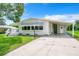 Mobile home exterior with carport and landscaping at 241 Menlo Park Ave, Davenport, FL 33897