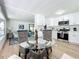 Bright dining area with glass table and wicker chairs at 241 Menlo Park Ave, Davenport, FL 33897