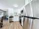 Modern kitchen with white cabinets and stainless steel appliances at 241 Menlo Park Ave, Davenport, FL 33897