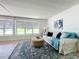 Living room featuring a sofa and ottoman with large windows at 241 Menlo Park Ave, Davenport, FL 33897