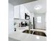 Modern kitchen with stainless steel appliances and white cabinets at 241 Menlo Park Ave, Davenport, FL 33897