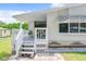 Home's exterior with a gray deck and white railing at 241 Menlo Park Ave, Davenport, FL 33897