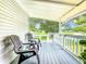 Inviting front porch with two comfortable chairs at 241 Menlo Park Ave, Davenport, FL 33897
