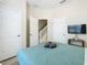 Spacious bedroom with a queen-size bed and private access to a bathroom at 7663 Sir Kaufmann Ct, Kissimmee, FL 34747