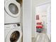 Stackable washer and dryer in a compact laundry room at 7663 Sir Kaufmann Ct, Kissimmee, FL 34747