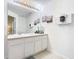 Well-lit bathroom with a double vanity and modern fixtures at 7663 Sir Kaufmann Ct, Kissimmee, FL 34747