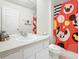 Clean bathroom with Minnie Mouse themed shower curtain at 7663 Sir Kaufmann Ct, Kissimmee, FL 34747