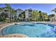 Large resort-style pool with plenty of surrounding lounge chairs at 7663 Sir Kaufmann Ct, Kissimmee, FL 34747