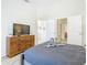 Main bedroom with a dresser and en-suite bathroom at 7663 Sir Kaufmann Ct, Kissimmee, FL 34747