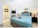 Comfortable bedroom with a queen-size bed and en-suite bathroom at 7663 Sir Kaufmann Ct, Kissimmee, FL 34747