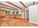 Kitchen with wood cabinets, granite counters, and terracotta tile floors at 8901 Nw 136Th Avenue Rd, Ocala, FL 34482