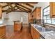 Open kitchen with wood cabinets, granite counters, and island at 8901 Nw 136Th Avenue Rd, Ocala, FL 34482