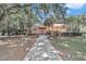 Spanish style home with brick walkway and lush landscaping at 8901 Nw 136Th Avenue Rd, Ocala, FL 34482
