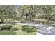 Paved driveway leading to the house, surrounded by green fields and trees at 8901 Nw 136Th Avenue Rd, Ocala, FL 34482