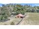 Aerial view of property showing barn and fenced pastures at 8901 Nw 136Th Avenue Rd, Ocala, FL 34482