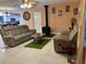 Spacious living room featuring a wood-burning stove and comfortable reclining sofas at 10566 Cr 671, Bushnell, FL 33513