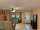 Living room with beige couches and large TV at 10566 Cr 671, Bushnell, FL 33513