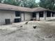 Large backyard with gravel patio and some fowl at 10566 Cr 671, Bushnell, FL 33513