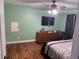 Primary bedroom with ceiling fan, dresser and hardwood floors at 10566 Cr 671, Bushnell, FL 33513