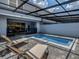 Private screened pool and patio with lounge chairs at 7472 Oakmoss Loop, Davenport, FL 33837