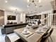 Modern dining room with a large table and view into the living room and kitchen at 7472 Oakmoss Loop, Davenport, FL 33837