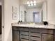 Modern bathroom with double vanity and granite countertops at 7472 Oakmoss Loop, Davenport, FL 33837