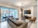Modern living room with large TV and sliding glass doors leading to a pool at 7472 Oakmoss Loop, Davenport, FL 33837