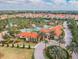 Community clubhouse with adjacent pool and tennis courts at 7472 Oakmoss Loop, Davenport, FL 33837