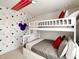 Fun bedroom with a bunk bed and Mickey Mouse themed wallpaper at 7472 Oakmoss Loop, Davenport, FL 33837