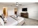 Comfortable bedroom with ensuite bathroom and TV at 7472 Oakmoss Loop, Davenport, FL 33837
