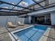Relaxing pool area with lounge chairs and covered patio at 7472 Oakmoss Loop, Davenport, FL 33837