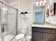 Clean bathroom with granite countertop, shower, and toilet at 7472 Oakmoss Loop, Davenport, FL 33837