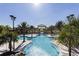 Resort-style pool with palm trees and a clubhouse at 7472 Oakmoss Loop, Davenport, FL 33837