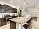 Kitchen island with seating and granite countertop at 7472 Oakmoss Loop, Davenport, FL 33837