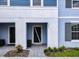 Inviting exterior of a light blue two-story home with a gray walkway at 7472 Oakmoss Loop, Davenport, FL 33837