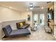 Bright bonus room with comfy seating and access to bedrooms at 7472 Oakmoss Loop, Davenport, FL 33837