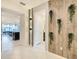 Bright and spacious entryway with wood-look wall and plants at 7472 Oakmoss Loop, Davenport, FL 33837