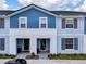 Modern two-story townhome with blue siding and neutral trim at 7472 Oakmoss Loop, Davenport, FL 33837