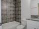Updated bathroom with granite vanity and grey tile at 604 W 12Th St, Lakeland, FL 33805