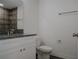 Modern bathroom with granite countertop, white cabinets, and gray tile at 604 W 12Th St, Lakeland, FL 33805