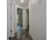 Hallway with light wood-look flooring and access to bedrooms at 604 W 12Th St, Lakeland, FL 33805