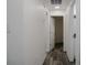 Clean hallway with wood-look floors and doors to other rooms at 604 W 12Th St, Lakeland, FL 33805