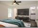 Main bedroom with en-suite bathroom and large TV at 604 W 12Th St, Lakeland, FL 33805