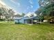 Light blue house with carport and large grassy yard at 13659 Sw 115Th Pl, Dunnellon, FL 34432