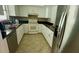 Galley kitchen with white cabinets and granite countertops at 13659 Sw 115Th Pl, Dunnellon, FL 34432