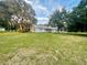 Light blue house with a large grassy yard and mature trees at 13659 Sw 115Th Pl, Dunnellon, FL 34432