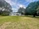 Light blue house with large yard and mature trees at 13659 Sw 115Th Pl, Dunnellon, FL 34432