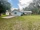 House with a large backyard, covered patio, and shed at 13659 Sw 115Th Pl, Dunnellon, FL 34432