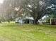 Spacious backyard with a large oak tree and shed at 13659 Sw 115Th Pl, Dunnellon, FL 34432