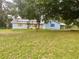 Light blue house with solar panels and large yard at 13659 Sw 115Th Pl, Dunnellon, FL 34432